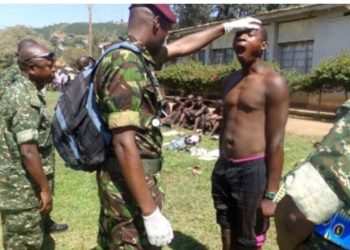 UPDF medical officers examines one of the youth who turned up for the UPDF recruitment exercise recently. FILE PHOTO