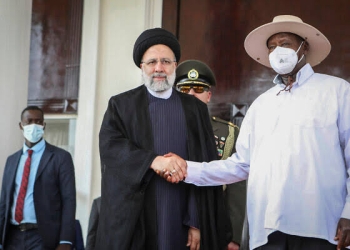 Iran’s President Ebrahim Raisi, left, shakes hands with Uganda’s President Yoweri Museveni, right, at State House in Entebbe, Uganda July 12, 2023. (Hajarah Nalwadda/AP)