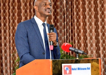Mr. Ramathan Ggoobi, Permanent Secretary of the Ministry of Finance, Planning and Economic Development, addresses the media during a press conference at Hotel Africana in Kampala, emphasizing the importance of tax education and revenue mobilization in Uganda's economic growth