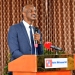 Mr. Ramathan Ggoobi, Permanent Secretary of the Ministry of Finance, Planning and Economic Development, addresses the media during a press conference at Hotel Africana in Kampala, emphasizing the importance of tax education and revenue mobilization in Uganda's economic growth