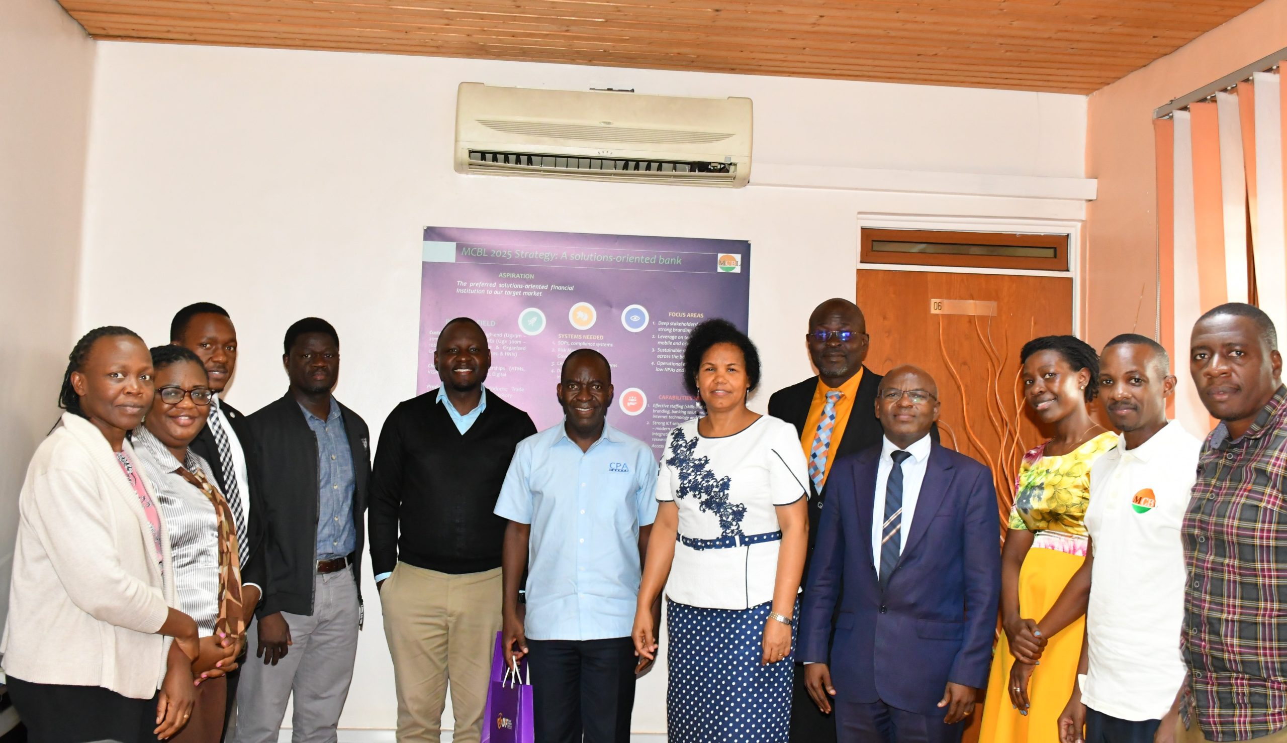Mercantile Credit Bank Limited Management team and DPF Team pose for a photo after the meeting.