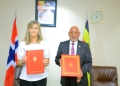 Uganda's Minister of Foreign Affairs, Gen. Odongo Jeje Abubakhar (right), and Norway's Ambassador to Uganda, Her Excellency Kristin Hermansen (left), exchange signed copies of the Memorandum of Understanding (MoU) on Political Consultations at the Ministry of Foreign Affairs in Kampala, Uganda, solidifying a new chapter in bilateral relations between the two nations.