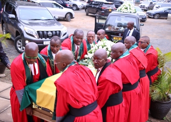 Judges carrying a casket containing Majanja's remains on Tuesday.