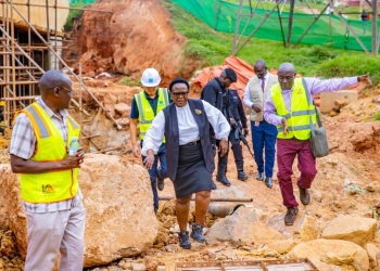 KCCA Executive Director Dorothy Kisaka inspects ongoing road rehabilitation works on Kayemba Road, a critical link in Kampala's transportation network. She is seen here assessing the progress and engaging with contractors on site, reaffirming her commitment to delivering high-quality infrastructure projects that transform the city's landscape.