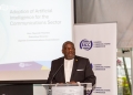 UCC Executive Director Nyombi Thembo addresses stakeholders during the launch of the AI Task Force, highlighting the need for a comprehensive framework to guide AI adoption