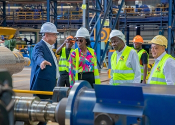 Minsiters Hon. Matia Kasaija, Evelyn Anite inside Roofings rolling mill at Namanve on Friday.(Courtesy photo)