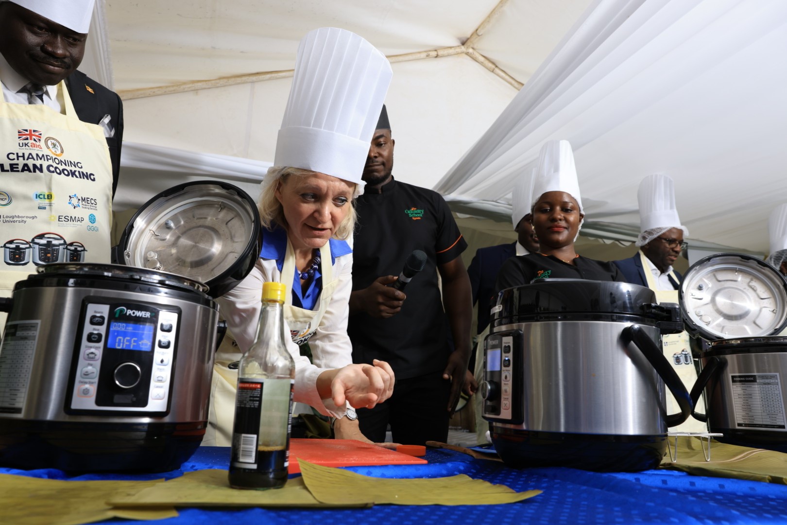 H.E. Kate Airey the British High Commissioner to Uganda demonstrates how to use the electric pressure cooker