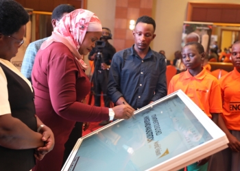 Rukia Nakadama, 3rd Deputy Prime Minister of Uganda, signs a commitment to support the "ENOUGH" Campaign, a national initiative aimed at ending child hunger and malnutrition in Uganda, during the launch event at the Sheraton Kampala Hotel on August 21, 2024.