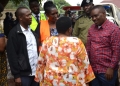 Nabbanja , the Prime Minister (with back) interacts with Erias Lukwago the Lord Mayor of Kampala (right) and other officials during the tragedy site inspection