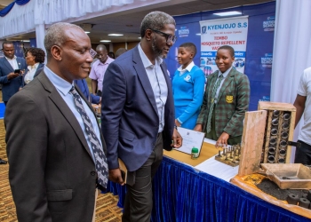Sam Mwogeza, the Stanbic Bank Executive Director touring the exhibition stalls during the Grand Finale