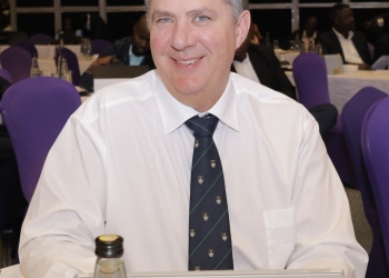 Dr. Warren D. Carew, Director of INFITX and a leading economist, delivers a keynote address at the 5th Business Trendsetters Forum in Kampala, Uganda. Dr. Carew emphasized the potential of AI-driven financial inclusion to propel Uganda's development prospects and urged authorities to boost support for technology adoption.