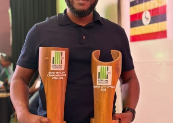 Stanbic Bank's head of marketing Daniel Ogong displays the most effective marketing campaign award and Brand of the year award given to Stanbic at the prestigious Africa Marketing Confederation Awards in Mombasa on Friday.