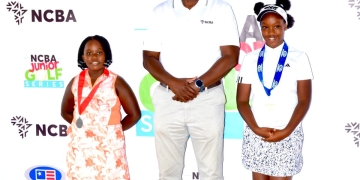 Mark Muyobo, CEO of NCBA Uganda (center), with young golf talents at the NCBA Junior Golf Series launch.