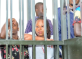 National Unity Platform (NUP) supporters, including Olivia Lutaaya (center), appear in the military court dock, facing charges of treachery and unlawful possession of explosive devices, in Kampala, Uganda, October 2024. The 16 supporters were sentenced to three months and 22 days despite their guilty plea, sparking concerns over the treatment of opposition supporters.