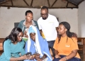 Head of Fintech Business at PostBank Uganda Brenda Mpoora (L), guiding a farmer on how to use the Wendi Mobile Wallet while Roger Gilbert Nyakahuma (Center Back), the IFDC BRIGHT project Financial Inclusion Manager and other officials and farmers look on. This was held today,15th October 2024 in Budwale Sub County, Mbale District, where Wendi by PostBank engaged with the community aimed at improving access to financial services to highland farmers through Village Saving and Loan Associations (VSLAs) via the Wendi Mobile Wallet.