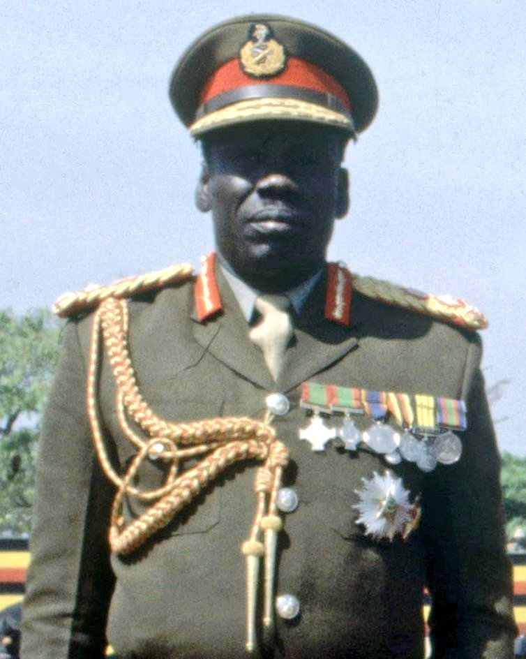 General Mustafa Adrisi, in full military fatigue, stands as a formidable figure during his tenure as Vice President and Chief of Defence Staff under Idi Amin's regime, exemplifying the authority and influence he wielded in Uganda's military history.