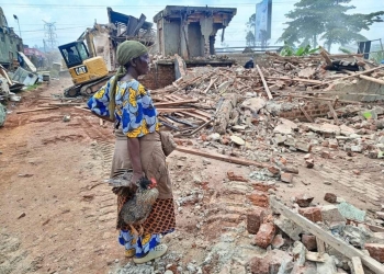 Namuddu Cissy one of the accused persons on remand at the place where her home used to be after eviction (Courtesy photo)