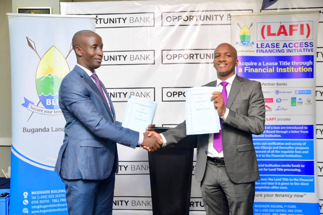 Buganda Land Board CEO, Simon Kabogoza (left), and Opportunity Bank Uganda CEO, Owen Amanya (right), shake hands after signing a landmark partnership to empower Bibanja holders in Uganda