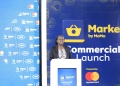 MTN MoMo's Okwi addressing the guests during the launch of a new online platform dubbed Market by MoMo