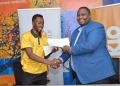 Ganesh Borra, CEO of Banana Life Investments (left), and Vianne Allan Ahura, CEO of Talkio Mobile (right), exchange signed copies of their partnership agreement, marking a new era of collaboration and growth in Uganda's telecommunications sector.