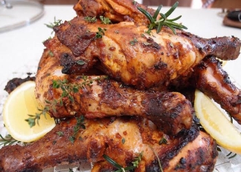 A perfectly golden-brown roasted chicken, fresh out of the oven - a delicious result of roasting chicken to perfection in the oven!
