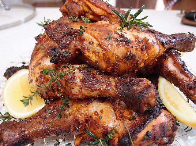 A perfectly golden-brown roasted chicken, fresh out of the oven - a delicious result of roasting chicken to perfection in the oven!