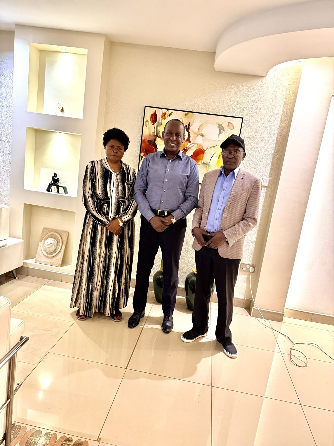 Mrs Prossy Mayanja and Gerald Mayanja (extreme right) with Captain Mike Mukula at his home on Monday this week.
