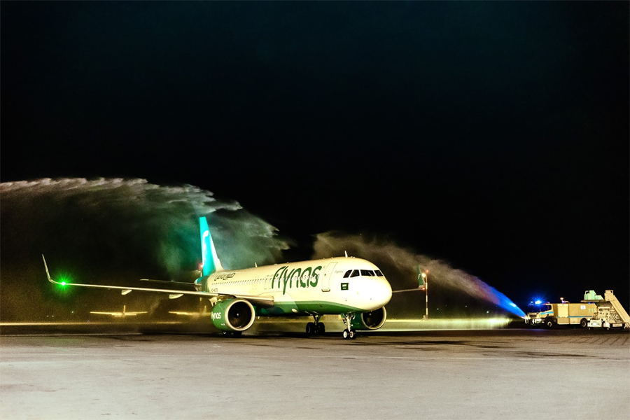 Here is a photo caption:A Flynas Airbus A320 Neo receives a ceremonial water cannon salute as it lands at Entebbe International Airport, marking the inaugural flight of the Saudi-based low-cost carrier's new route connecting Entebbe to Riyadh, January 16, 2025. 