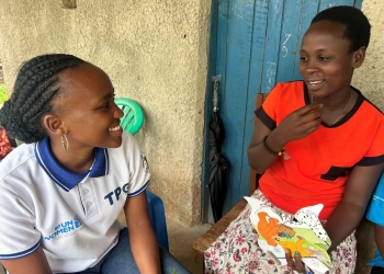 Grace (in red blouse) having a light moment talking about her journey with a staff member of TPO. Photo: UN Women/Haruko Kusunoki