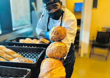 Jonathan Walinda, a Ugandan-born bakery chef, expertly crafts a delicious pastry at NUA restaurant in Almadina Heritage, California, where he showcases his culinary skills and creativity.