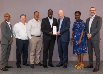 Vivo Energy Group CEO Stan Mittelman (3R), presents the Vivo Award to the Uganda Team led by the MD, Joanita Mukasa Menya (2R) and the officials at the conference recently.