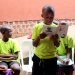 Newly elected Media Club head Hannington Kajja reads from "The Smart Media Guide" during a group session at JesJonny Primary School in Mukono Municipality, Uganda.