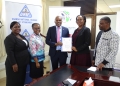 TradeMark Africa Country Director Anna Nambooze (right) and Uganda National Bureau of Standards Executive Director Eng. James Kasigwa (Left) exchange documents after signing a UGX 5.5 billion partnership agreement to support Ugandan MSMEs.