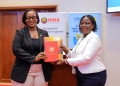 Mercy K. Kainobwisho, Registrar General of URSB (left), formally hands over marriage registration duties to Rosemary Kisembo, Executive Director of NIRA, in Kampala on Thursday. The transfer is part of a government effort to streamline public services.