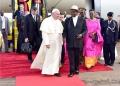 Ugandan President Yoweri Museveni welcomes Pope Francis at Entebbe International Airport during the 50th-anniversary celebrations of the canonization of the Uganda Martyrs.