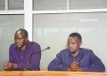Two Ntungamo District officials stand before the Anti-Corruption Court in Kampala.