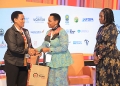 (L-R) Doreen Katusiime, Permanent Secretary Ministry of Tourism Wildlife & Antiquities hands over a present to Col. Edith Nakalema, Head of State House Investors Protection Unit as Rebecca Nalumu, Senior Manager Special Economic Zone operations at Uganda Free Zone Authority looks on. PPU PHOTO