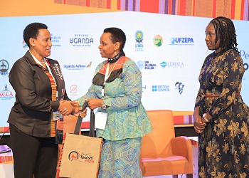 (L-R) Doreen Katusiime, Permanent Secretary Ministry of Tourism Wildlife & Antiquities hands over a present to Col. Edith Nakalema, Head of State House Investors Protection Unit as Rebecca Nalumu, Senior Manager Special Economic Zone operations at Uganda Free Zone Authority looks on. PPU PHOTO