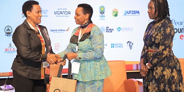 (L-R) Doreen Katusiime, Permanent Secretary Ministry of Tourism Wildlife & Antiquities hands over a present to Col. Edith Nakalema, Head of State House Investors Protection Unit as Rebecca Nalumu, Senior Manager Special Economic Zone operations at Uganda Free Zone Authority looks on. PPU PHOTO