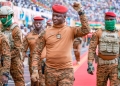 Captain Ibrahim Traoré raises his hand in acknowledgement, a steady wave cutting through the air above the boisterous crowd of his fervent supporters. Their cheers and applause create a palpable wave of energy, a vibrant testament to the connection between the leader and the people rallying behind his vision for Burkina Faso.