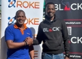 Joseph Byaruhanga,(L), Brand and Marketing Manager at Roke Telkom poses for a photo with Mourice Aliganyira,(R), Head of Marketing and Brand at BLACK