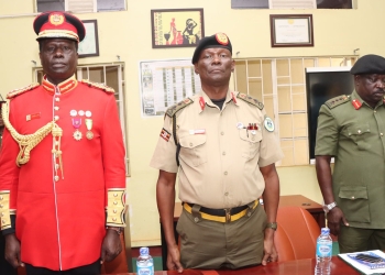 L-R: Maj. Gen. Francis Okello, Maj. Gen. George Igumba, and Lt. Gen. Peter Elwelu prepare for documentation at Mbuya