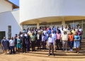 PhD Students join the Ag. Deputy Vice Chancellor in a group photo.