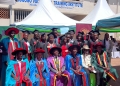 Some of the leaders from Zziwa Hair Academy, Lugogo Vocational Institute and Steven Kibuuka,(1st R) a representative of KCB Bank pose for a photo with some of the graduates