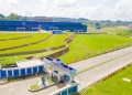 A bird's-eye view" immediately tells the reader they are seeing an expansive, top-down perspective. This often conveys the scale and layout of the facility, emphasizing its physical presence and the vastness of the 300-acre site in Matugga.
