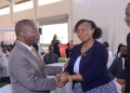 Minister David Bahati (left) chats with Irene Mutyaba Kabiri, the Corporate Banking Director at Absa Bank Uganda during the UMA 2nd Financial Symposium. Looking on is Dr. Ezra Muhumuza Rubanda, the UMA Executive Director
