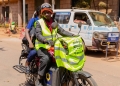 A boda boda rider on an electric motorcycle embodies the shift towards cleaner, more efficient transportation in Kampala