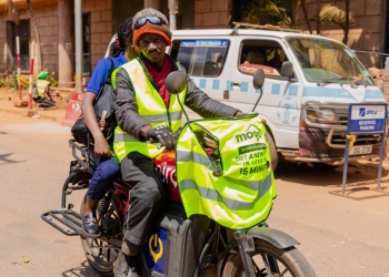 A boda boda rider on an electric motorcycle embodies the shift towards cleaner, more efficient transportation in Kampala