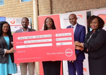 Absa Bank Uganda officials present UGX 100 million to World Vision representatives.