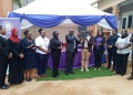 Justice Geoffrey Kiryabwire handing over Small Claims Procedure Register to RCC Njuki who later handed it over to Kawempe Chief Magistrate Roseline Nsenge.
